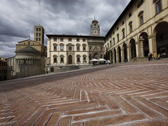 Visite la ville de Arezzo la Piazza Grande toute en pente